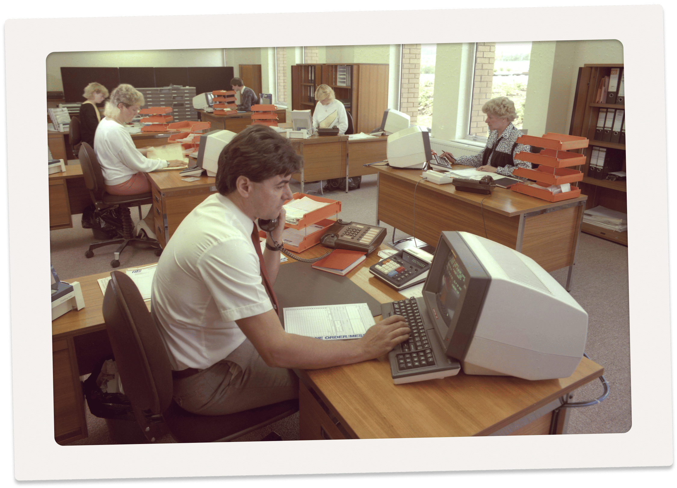 People working in an office in the 1970s