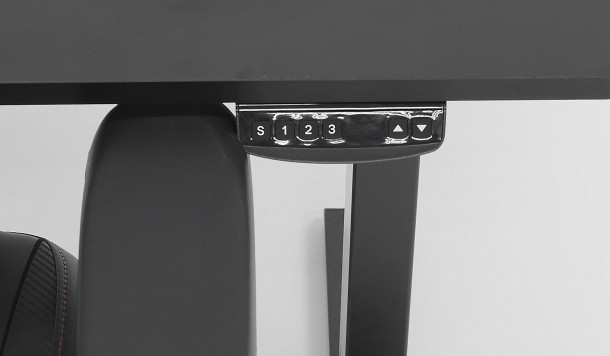 Large control panels on typical desks that restrict chair movement